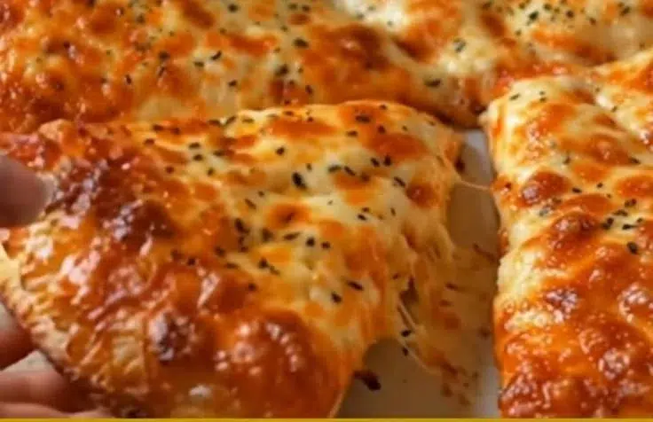 Homemade 3-ingredient cottage cheese pizza crust on a wooden cutting board.
