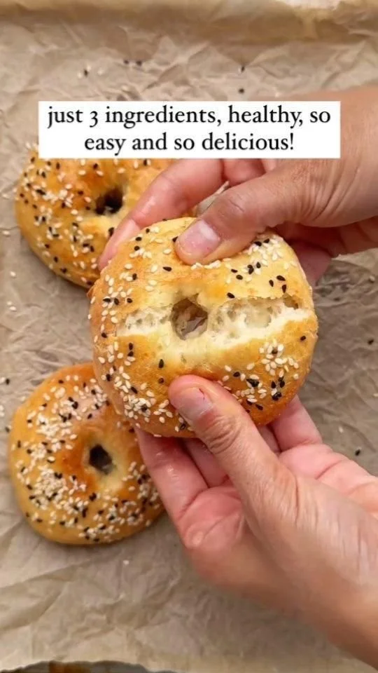 A variety of freshly baked bagels with different toppings and flavors.
