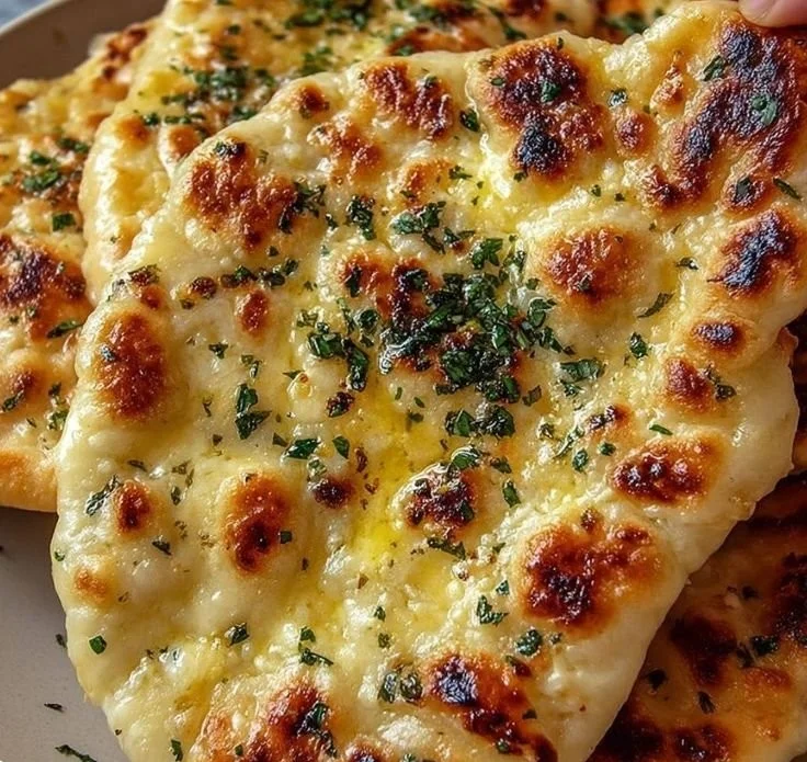 Cottage Cheese Garlic Skillet Naan served in a skillet with garlic and herbs.