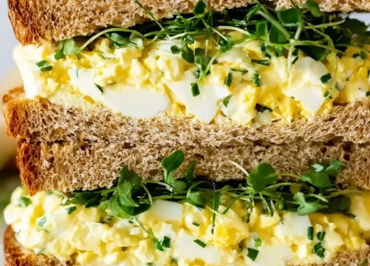 Creamy cottage cheese egg salad served in a bowl with garnish.