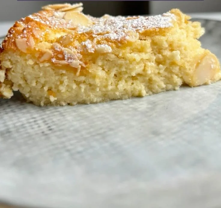 Lemon Almond Cottage Cheese Cake topped with almonds and lemon zest