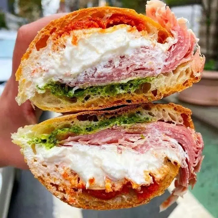 Prosciutto and Stracciatella sandwich with fresh ingredients and artisan bread